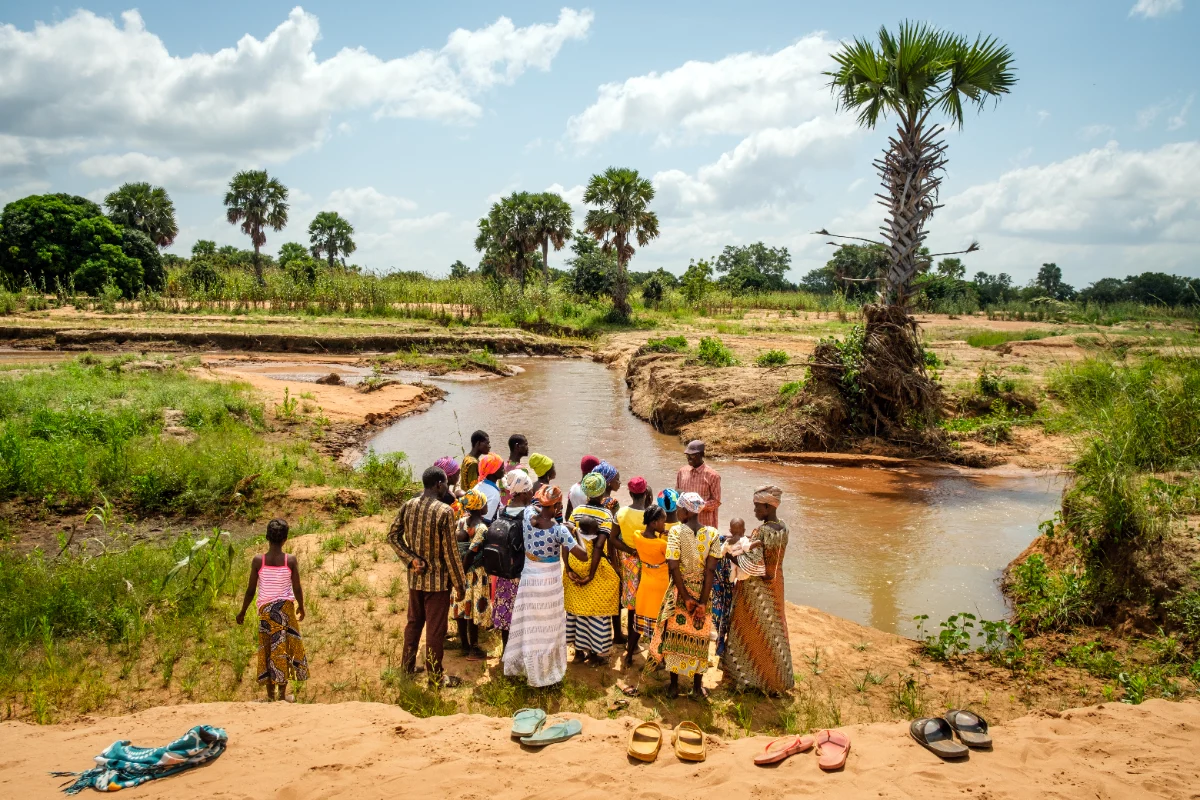 Believers gathered at a river for baptism