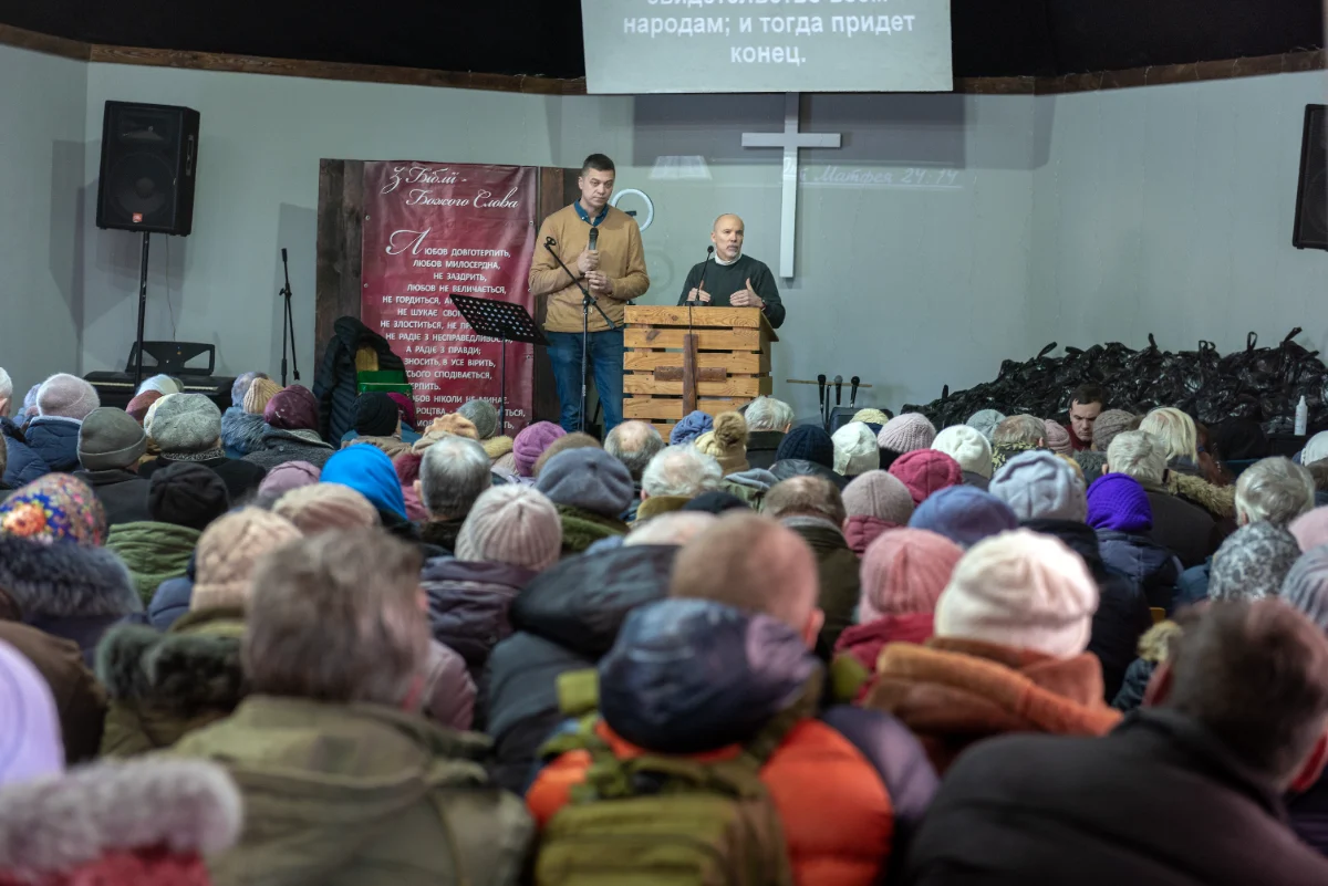 A packed church gathering in winter