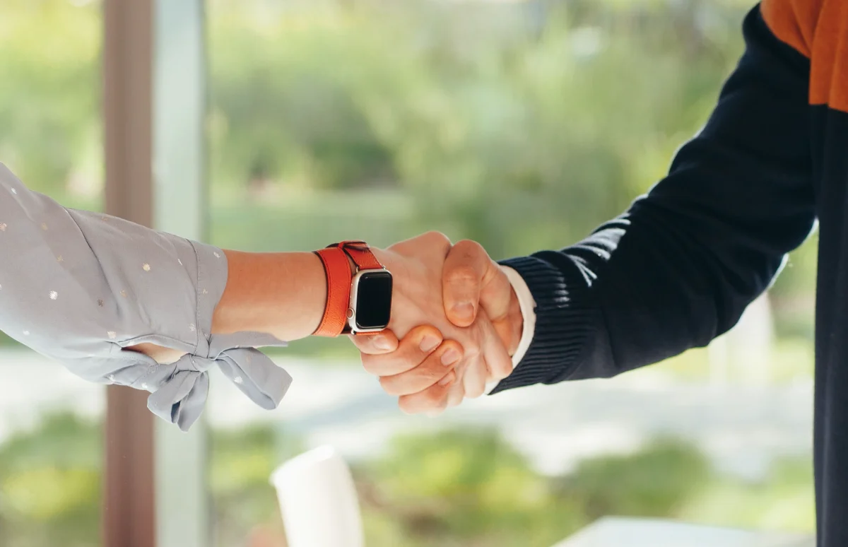 Outgoing and incoming leader shaking hands