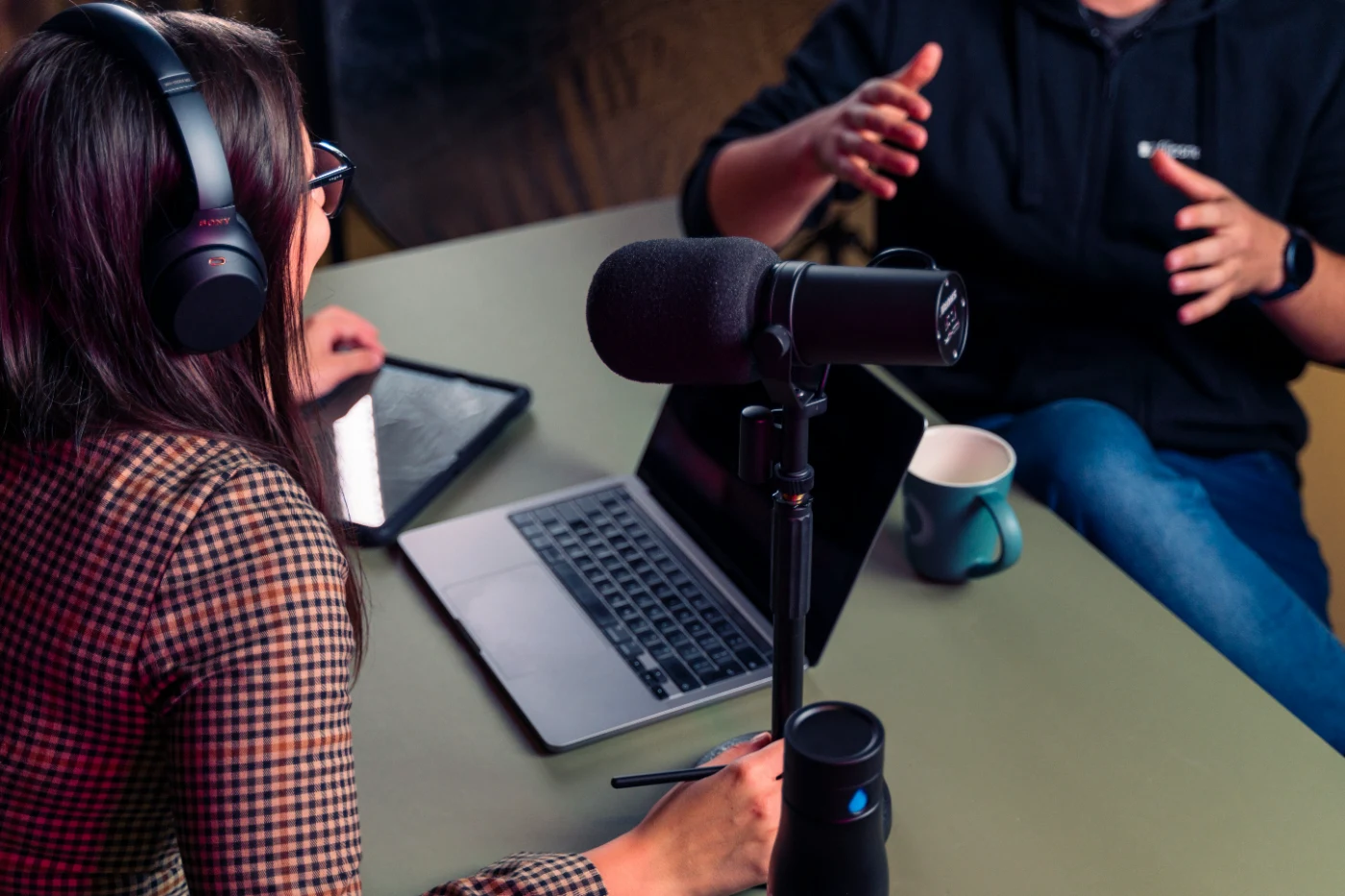 Host and guest recording a podcast