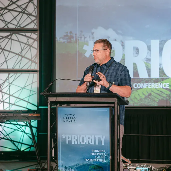 A speaker addressing the conference from the podium