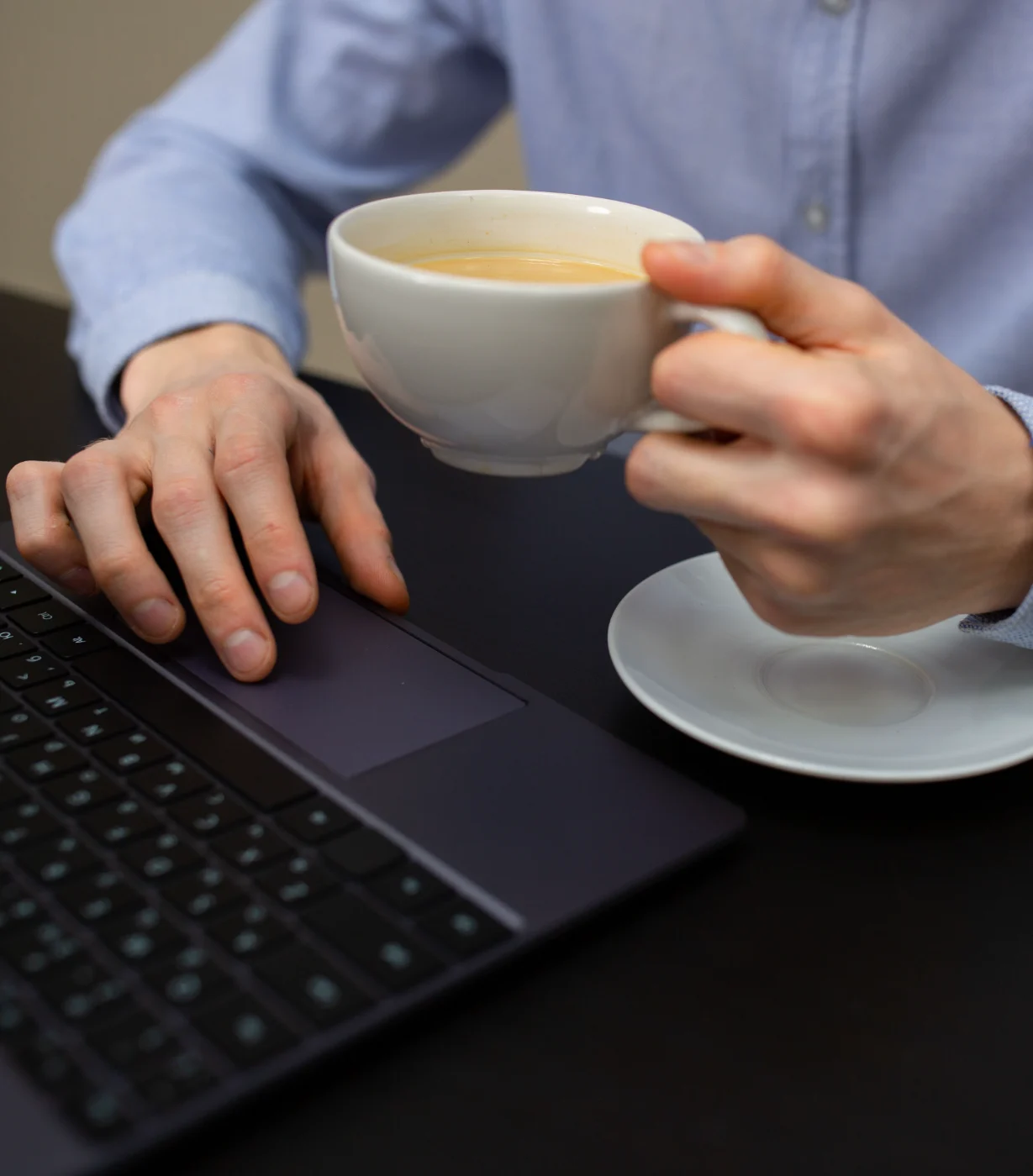 Agency staff member at work, laptop open